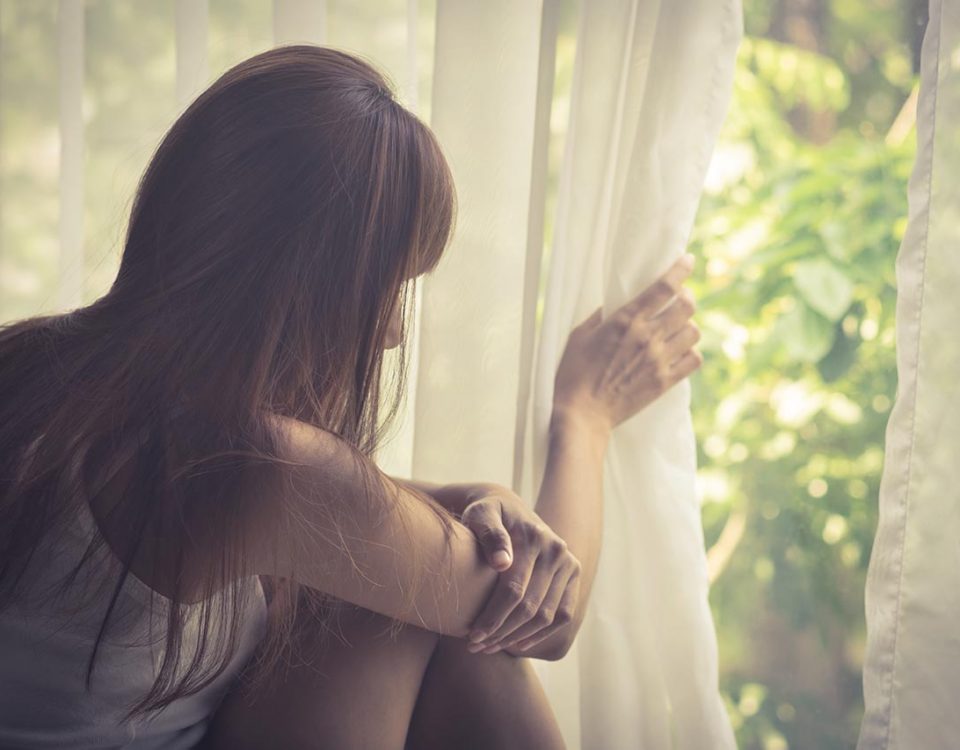 woman with anxiety looking outside